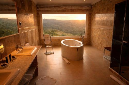 a large bathroom with a tub and a large window at Los Cinco Enebros Hotel & Spa by Bossh! Hotels in Robledo de Chavela
