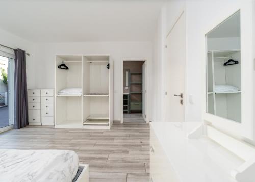 a white bedroom with white cabinets and a bed at Large Villa - Private Pool - 6 Bedrooms in Albufeira