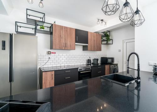 a kitchen with a sink and a refrigerator at Large Villa - Private Pool - 6 Bedrooms in Albufeira