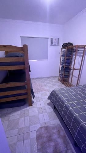 a bedroom with a bed and two bunk beds at Host Família Catarina in Guarulhos
