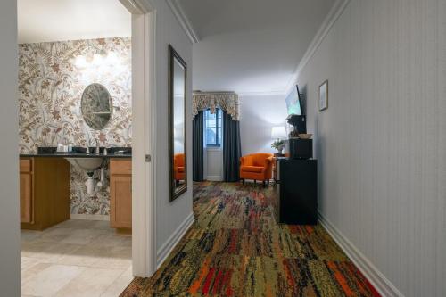 a hallway with an orange chair in a room at Red Coach Inn in Niagara Falls