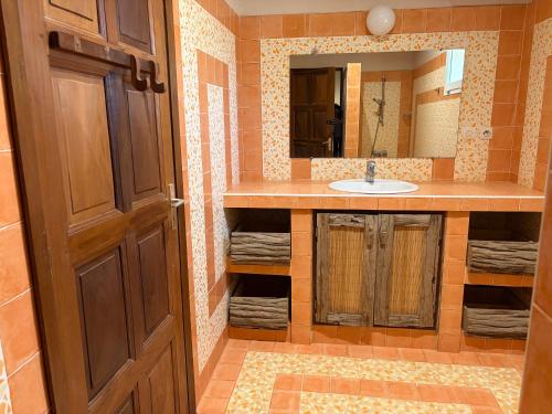 a bathroom with a sink and a mirror at Luciana annexe in Mbour