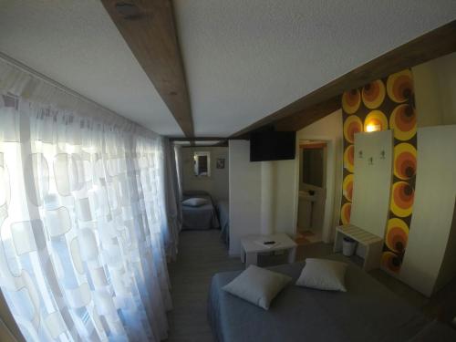a room with a bed and a large window at B&B Seventy Design in Dimaro