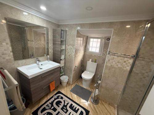 a bathroom with a toilet and a sink and a shower at Rossio Downtown in Lisbon