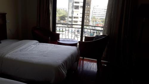 a bedroom with a bed and a window with a view at FT Hotel in Addis Ababa