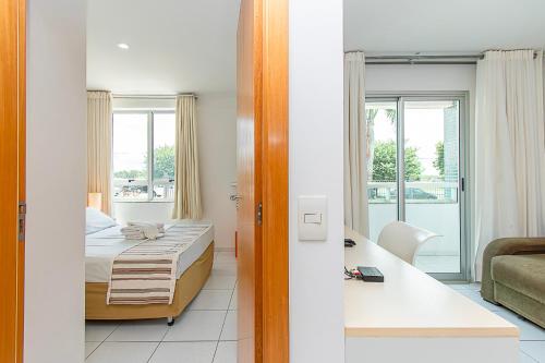a bedroom with a bed and a room with a view at Premier Residence Residencial em Brasília 67961 in Brasília