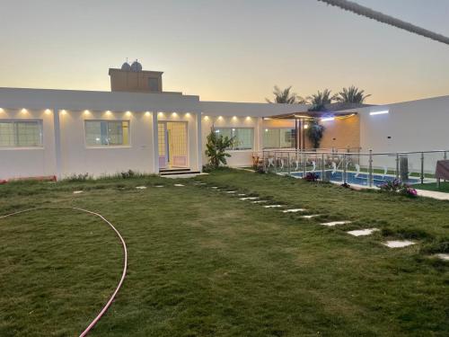 a house with a yard with a swimming pool at شقه مفروشه in Hail