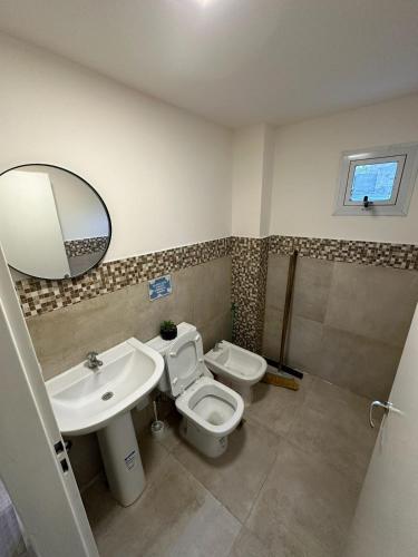a bathroom with a sink and a toilet and a mirror at Terrazas del Gracian in La Puerta