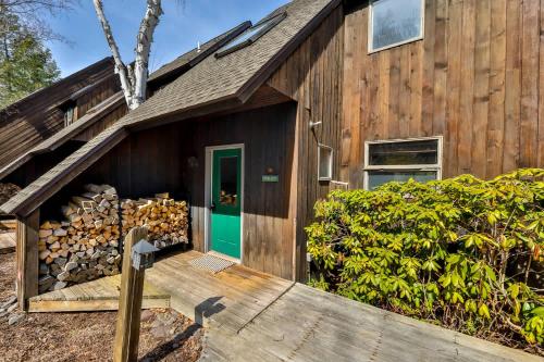 a wooden house with a green door at Windham Mountain Condo with Deck & Stunning Views in Windham