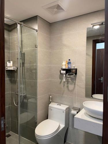 a bathroom with a shower and a toilet and a sink at KP Home in Xuân Trach