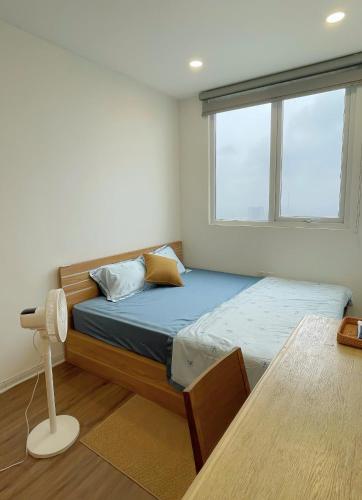 a bedroom with a bed and a window at KP Home in Xuân Trach