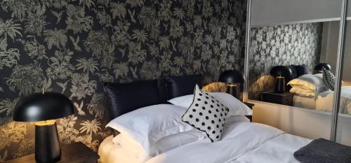 a bedroom with a mirror and a bed with pillows at Kings Sconce in South Muskham