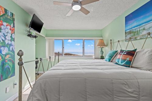 a bedroom with a bed with a view of the ocean at A-110, Pinnacle Port in Panama City Beach