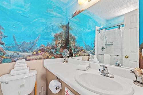 a bathroom with a fish mural on the wall at A-110, Pinnacle Port in Panama City Beach