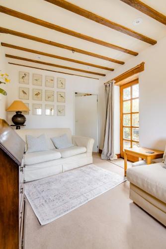 a living room with a couch and a table at Norfolk Broads Bolthole in Stokesby