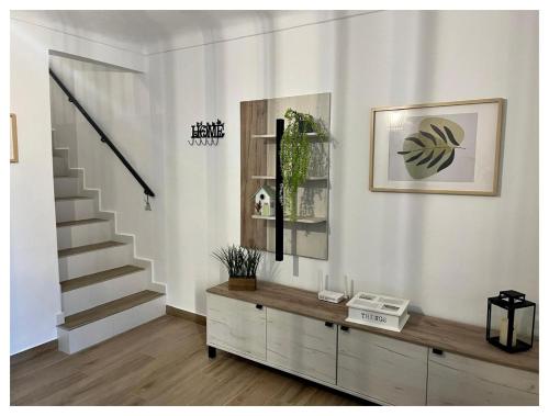 a living room with a staircase and a wooden cabinet at Casa Veracruz in Alora