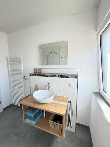 a bathroom with a white sink and a mirror at Ferienwohnungen Haus Jose in Cochem