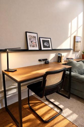 a desk with a chair in a living room at Flexhome West Town - Spacious 2BR Duplex - Sleeps 8 in Chicago