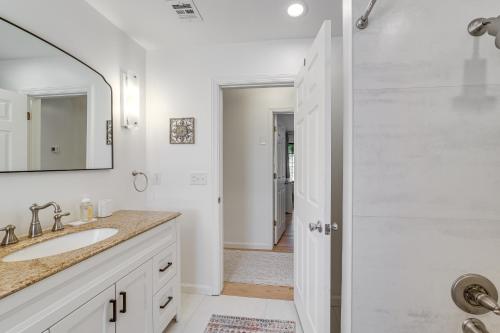 a white bathroom with a sink and a shower at Midtown Tulsa Gem w/ MCM Decor: Private Deck, Yard in Tulsa