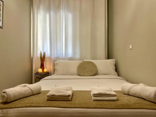 a large bed with two towels on top of it at Dirfys House in Káto Stení