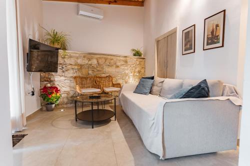 a living room with a couch and a table at The Courtyard Episkopi Guest Houses in Episkopi Limassol