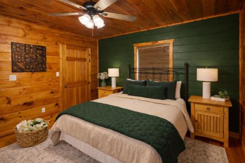 a bedroom with a bed and a ceiling fan at Wilderness Lodge, Hot Tub, Pool Table, Pool Access, WIFIeach paid day in Sevierville