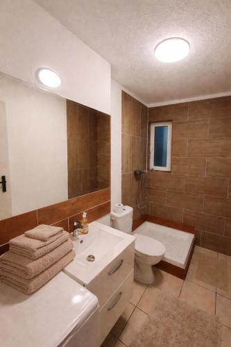 a bathroom with a tub and a toilet and a sink at Basel Access Apart - Habsheim in Habsheim