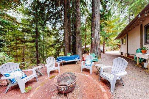 a group of chairs sitting around a fire pit at Coastal Cabin in Gualala
