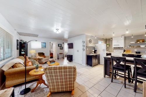a living room and kitchen with a couch and a table at Coastal Cabin in Gualala