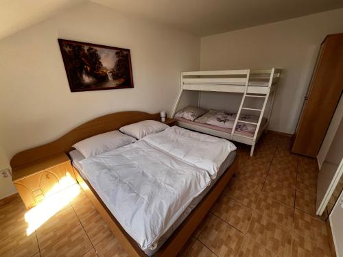 a bedroom with a bed and a bunk bed at Penzión Dvorec in Dvorec