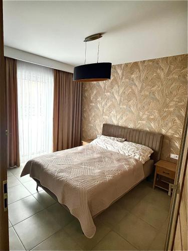 a bedroom with a bed and a pendant light at Czarno biały in Racibórz
