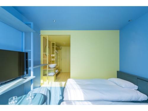 a bedroom with a bed and a tv in a room at toggle hotel suidobashi - Vacation STAY 06299v in Tokyo