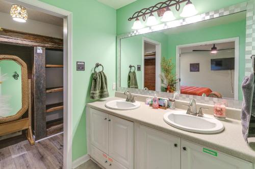 a bathroom with two sinks and a large mirror at Explore Tupelo & Natchez Trace! Southern Getaway in Tupelo