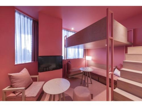 a small room with red walls and a bunk bed at toggle hotel suidobashi - Vacation STAY 13467v in Tokyo