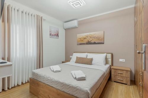 a bedroom with a bed with two towels on it at House Seda in Limenas