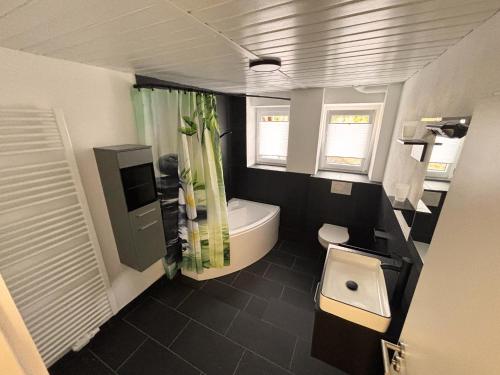 a bathroom with a tub and a toilet in it at pfefferHÄUSL in Regen