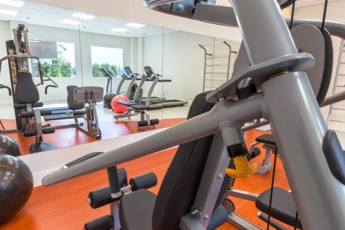 a gym with several treadmills and exercise bikes at Ramada by Wyndham Campinas Viracopos in Campinas