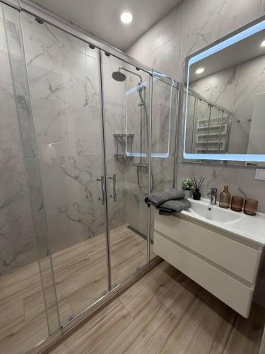 a bathroom with a shower and a sink at Дивоніч guest house in Kyiv