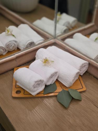 a pile of towels in front of a mirror at Casa Fiori San Miguel de Allende in San Miguel de Allende