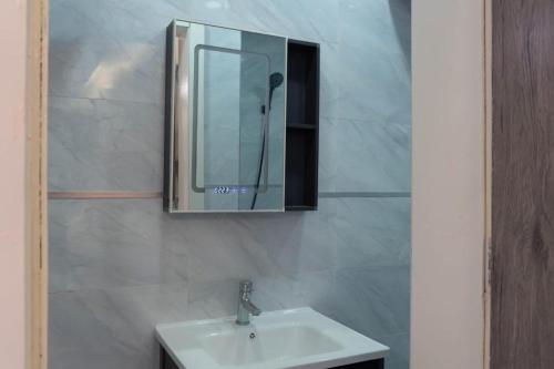 a bathroom with a sink and a mirror on the wall at Résidence Madior D3 in Dakar