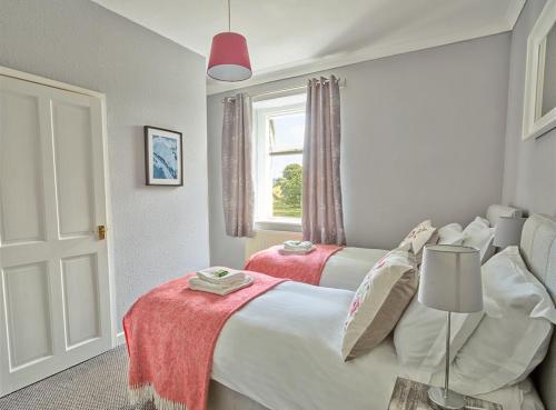 a bedroom with two beds and a window at The Station Inn - Ribblehead in Ribblehead Station