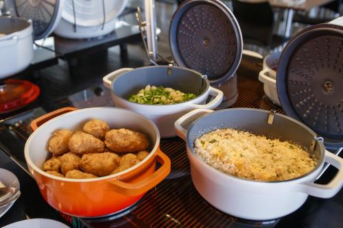 a table with three bowls of food on a counter at Ramada by Wyndham Campinas Viracopos in Campinas