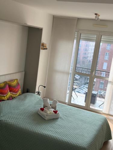 a bedroom with a bed with two towels on it at MarteNik Apartment, vicino San Raffaele e Milano in Vimodrone