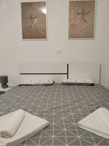 a room with two beds on a tiled floor at Lorber house Štinjan - Studio in Pula