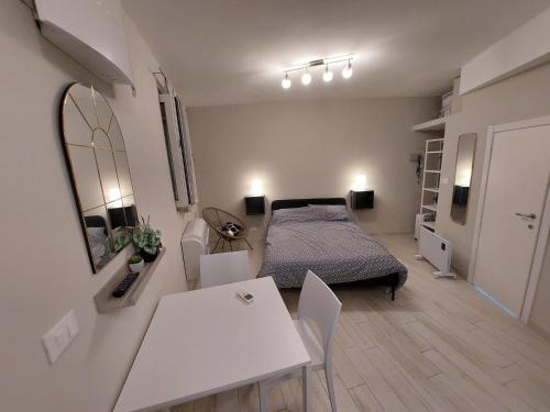 a bedroom with a bed and a table and chairs at La Casetta in Finale Ligure