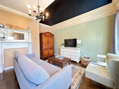 a living room with a couch and a tv at Haven at Hazel Downtown Loft in Demorest