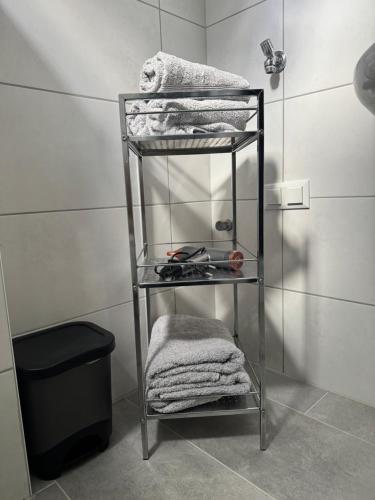 a shelf in a bathroom with towels on it at Apartment Leitha Living Cozy in Götzendorf an der Leitha
