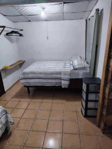 a bedroom with a bed in a room at Casa Amarilla hostel in Bajo Boquete