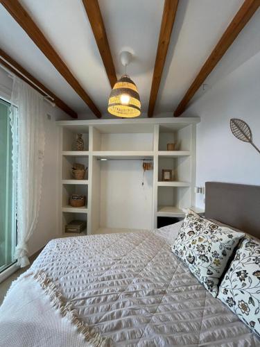 a bedroom with a large bed and a ceiling at Aegean Breeze in DYO CHORIA TINOS in Triandáros
