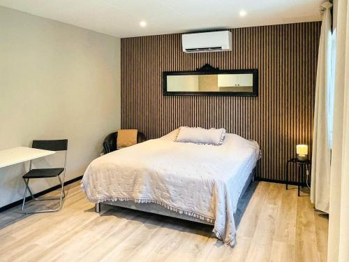 a bedroom with a bed and a mirror on the wall at 4 star holiday home in SÖLVESBORG in Sölvesborg